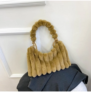 Close-up of fluffy plush handbag featuring unique vertical thick stripe texture and soft handle