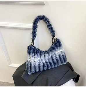 Detailed view of blue and white gradient faux fur handbag with stylish pleated handle