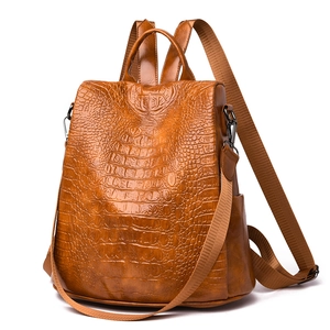 Brown crocodile pattern PU leather backpack with adjustable straps and metallic hardware