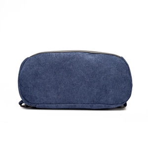 Bottom view of navy blue corduroy backpack featuring durable black leather piping accents