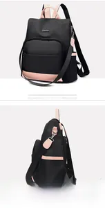Vue latérale détaillée du sac à dos en nylon noir avec bordure rose et poche latérale