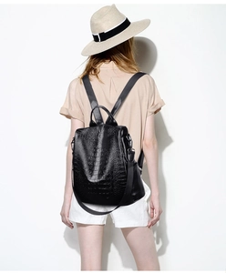 Detail of the black crocodile pattern texture on a stylish women leather backpack