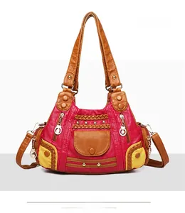 Detail of vintage tote bag featuring colorful patchwork patterns and metallic gold studs