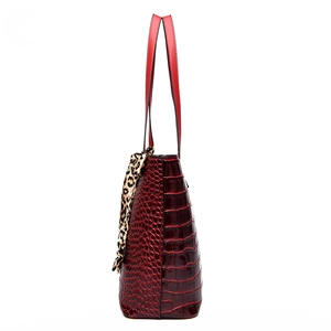 Burgundy faux leather bucket bag with crocodile embossing and leopard print scarf handle