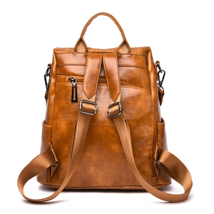 Back view of brown leather backpack with anti-theft zipper and adjustable straps