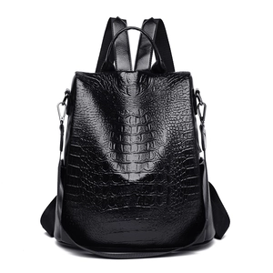 Detailed view of the luxury black crocodile pattern texture on the PU leather backpack