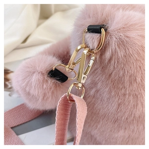 Detailed close-up of pink faux fur bag featuring gold metal hardware and fabric strap