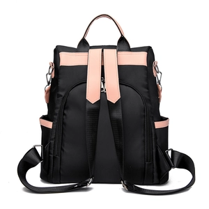 Sac à dos femme en nylon noir avec détails en cuir rose et poche antivol à l'arrière