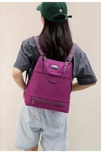 Close-up of durable purple Oxford fabric backpack featuring high-density texture and sleek metal zip