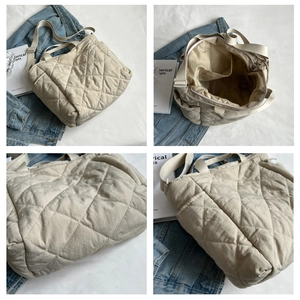 Detail view of beige quilted tote bag showing interior compartments and waterproof nylon fabric