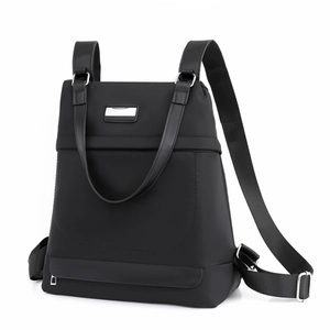 Minimalist black oxford fabric backpack with adjustable leather straps and metal detail