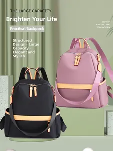 Close-up of black and pink waterproof nylon backpacks with yellow contrast straps