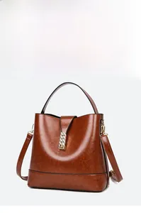 Detailed view of brown retro textured tote with a golden rectangular metal buckle closure
