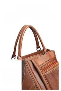 Detail showing the brown soft leather handles and precision stitching on the large tote bag