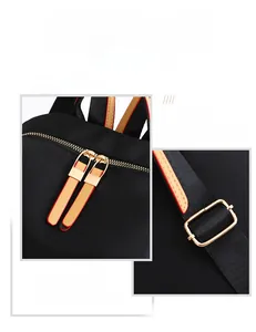 Detail of high-quality gold metal zippers and buckles on a black nylon travel backpack