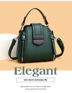 Detail of dark green matte leather bucket bag with silver zipper and black shield lock