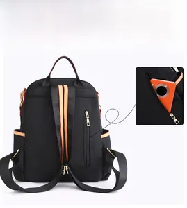 Detail of rear vertical zipper anti-theft pocket on nylon backpack with contrast trim