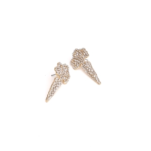 Macro detail of carrot stud earrings with gold plating and paved white crystals