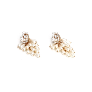Detailed view of layered cream pearl tassels with sparkling crystals and gold plating
