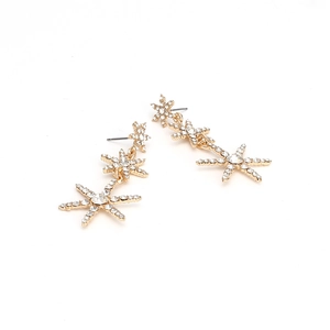 Elegant gold drop earrings featuring sparkling rhinestone-studded stars on a white backdrop