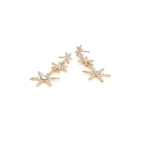 Gold star drop earrings with three dangling rhinestones in a minimalist design