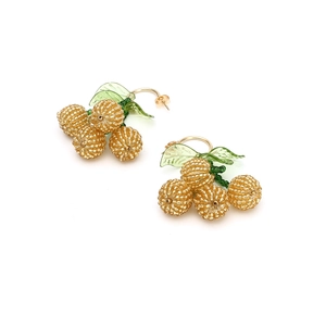 Close-up of handmade beaded cherry earrings with yellow berries and green leaves