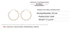 Detail of 4.0cm gold hoop earrings with twisted metal and white faux pearls