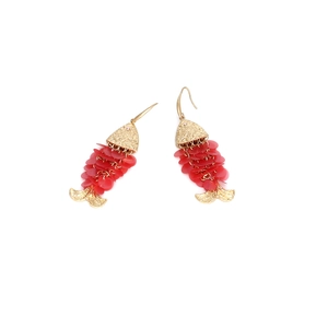 Detail of handmade fish drop earrings with golden metal and red sequin scales