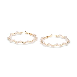 Detailed view of oversized gold geometric hoop earrings with woven pink faux pearls