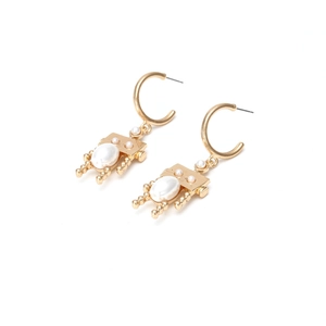 Modern gold robot earrings with white pearl accents on a clean white background