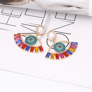 Gold evil eye earrings with colorful crystals and white pearls in exotic design