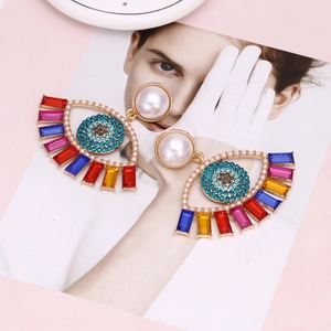 Exaggerated evil eye drop earrings with pearls, blue crystals and colorful gemstones