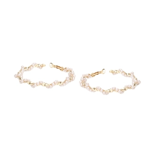 Elegant gold twisted metal hoop earrings with wrap-around white pearls in a geometric design
