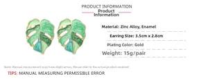 Detailed view of monstera leaf earrings with green enamel and 3.5cm x 2.8cm dimensions