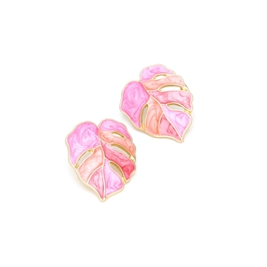 Detail of Monstera leaf earrings with gold metal edges and pink enamel gradient effect