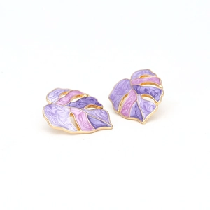 Detailed close-up of monstera leaf earrings with purple and pink enamel and gold plating