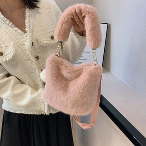 Chic pink plush faux fur bucket bag for women featuring soft handle and crossbody strap