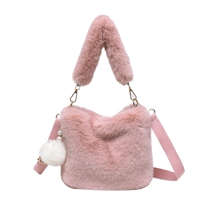 Pink plush faux fur bucket bag for women with shoulder strap and pompom charm