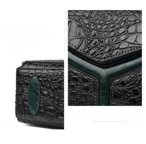 Close-up of green crocodile texture leather with precise stitching and cross lock