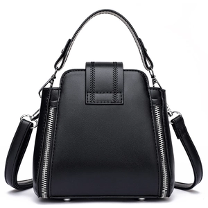 Minimalist black matte leather bucket bag with V-shaped stitching and metallic zipper detail