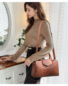 Detail of dark brown faux crocodile skin texture on a vintage style tote bag