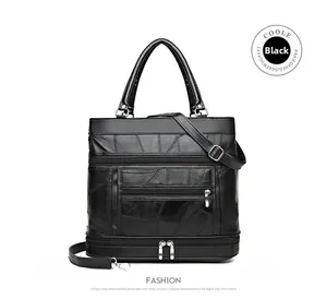 Close-up of black leather handbag featuring geometric stitching and multiple zip pockets