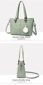 Close-up of green crocodile texture bucket bag with white pompom and pearl charm