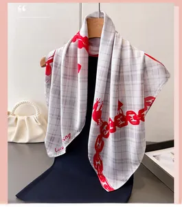 Detail of a plaid silk scarf with red chain print and Love letters on a wooden hanger