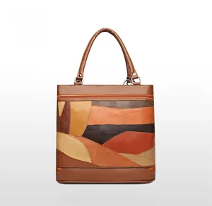Detail view of the back of a vintage leather patchwork tote bag with warm earth tones