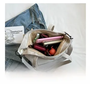 Top view of spacious canvas tote bag interior showing tablets and daily essentials