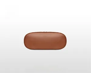 Detailed macro view of the oval bottom and stitching on this brown leather tote bag