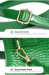Detail of golden metal buckles and adjustable strap on green crocodile pattern bag