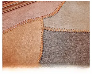 Detailed macro view of retro patchwork soft leather texture with zigzag stitching detail