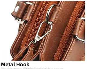 Close-up of durable silver metal hardware hook on brown lychee grain leather bag